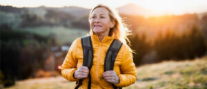 Woman hiking with sunset in background